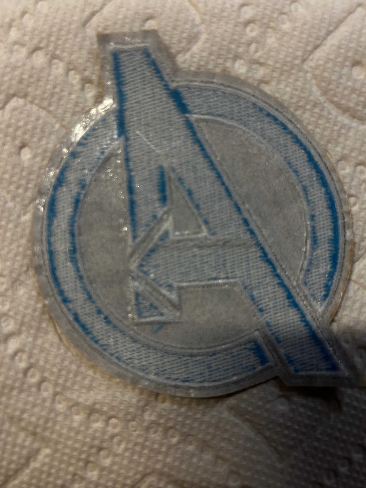 Avengers Marvel Logo iron-on patch with embroidered blue and silver Avengers insignia