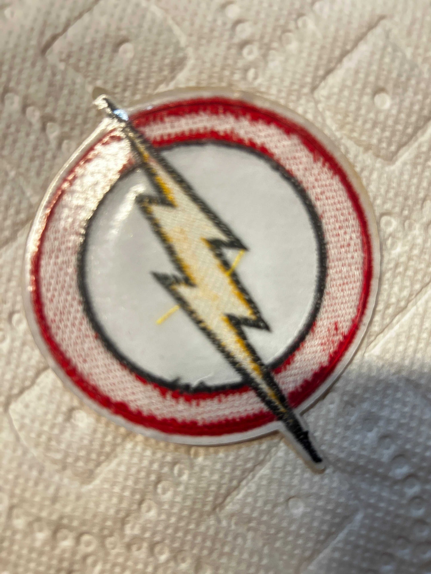 The Flash 3-inch iron on logo patch with red and gold embroidered lightning bolt emblem