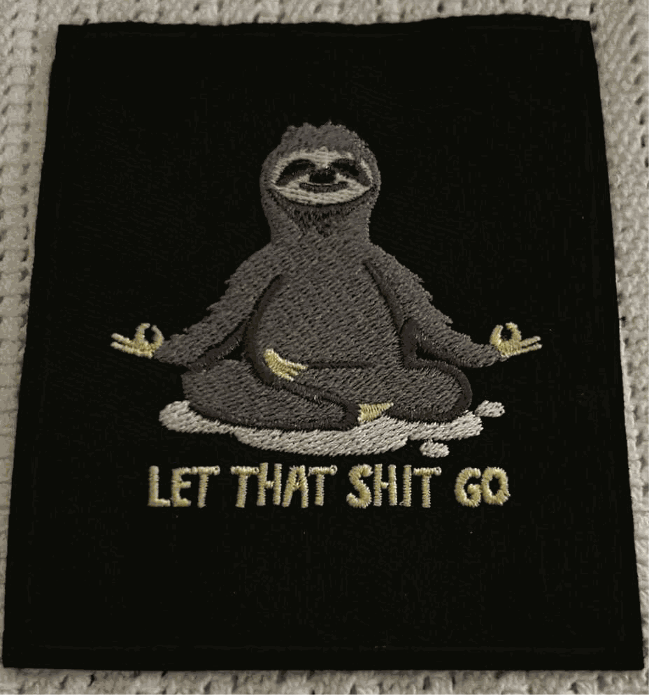 Black embroidered patch featuring a meditating sloth with the phrase "LET THAT SHIT GO" in beige lettering.