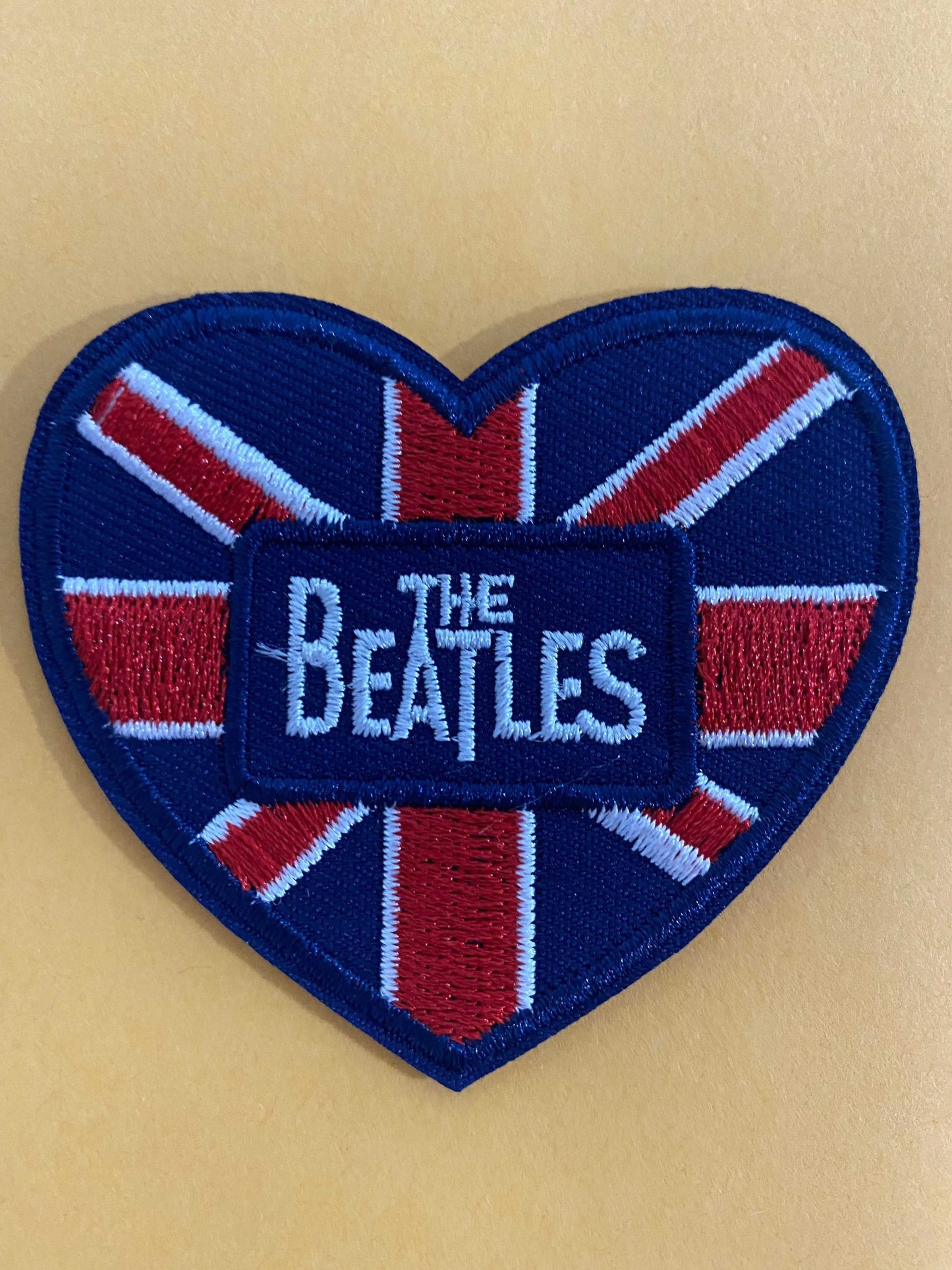 Heart-shaped embroidered Beatles patch with Union Jack design and logo in the center