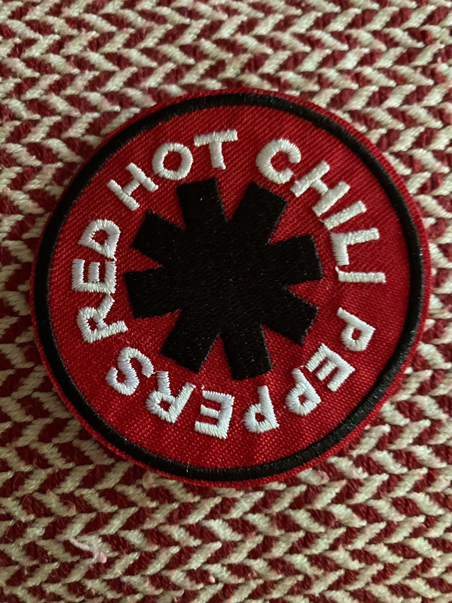 Red Hot Chili Peppers embroidered patch with red background and black asterisk logo