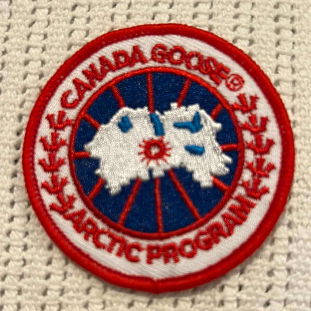 Canada Goose Arctic Program embroidered round patch with red, white, and blue design on white fabric background