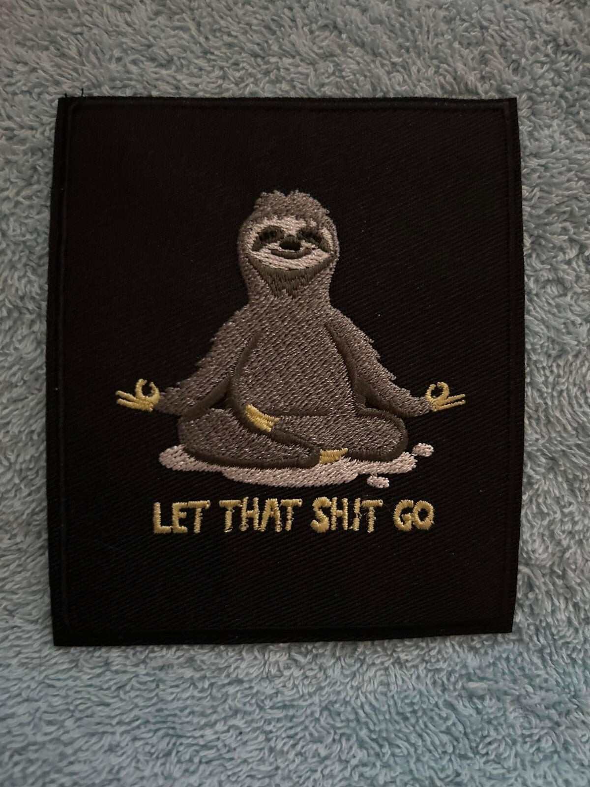 Let That Shit Go patch silver and black embroidered iron-on 4x3.75 inches motivational design