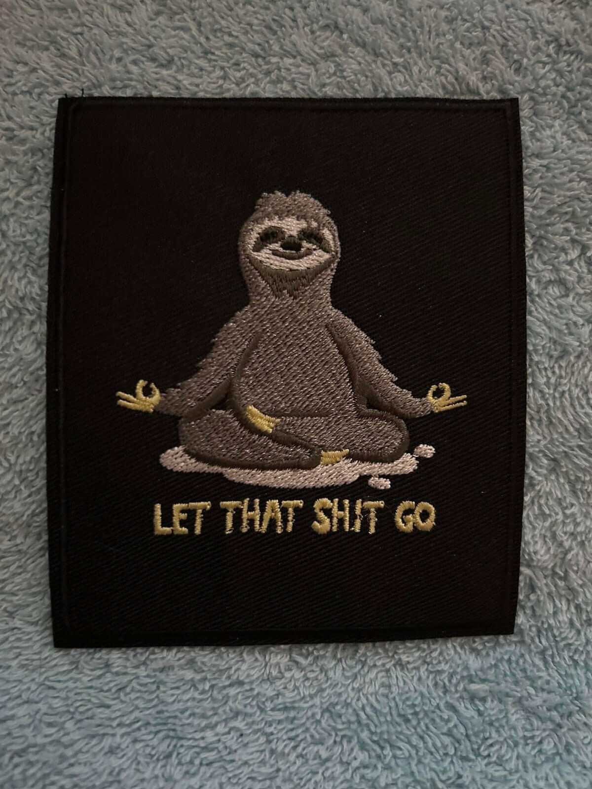 Let That Shit Go patch silver and black embroidered iron-on 4x3.75 inches motivational design
