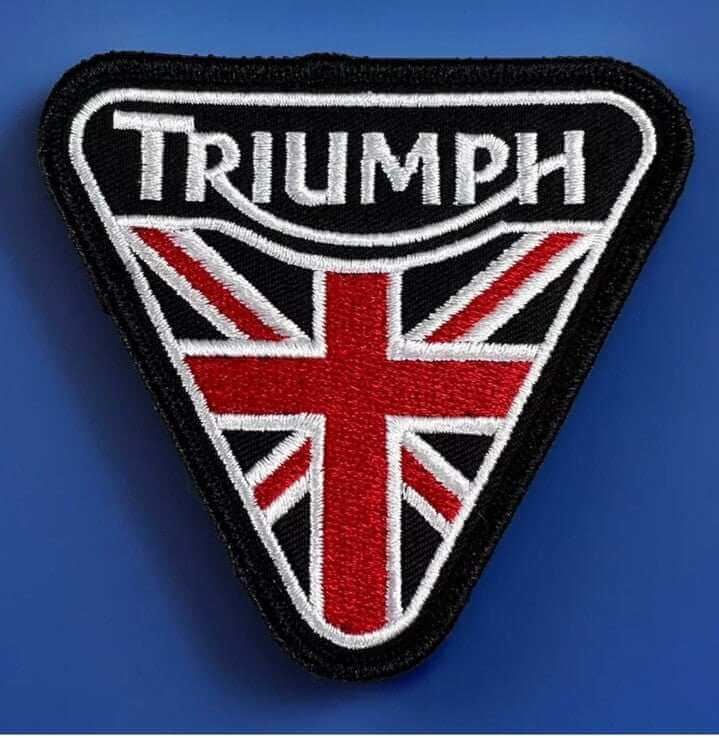 Embroidered union jack motorcycle patch featuring 'Triumph' text on a triangular design for bags and jackets.