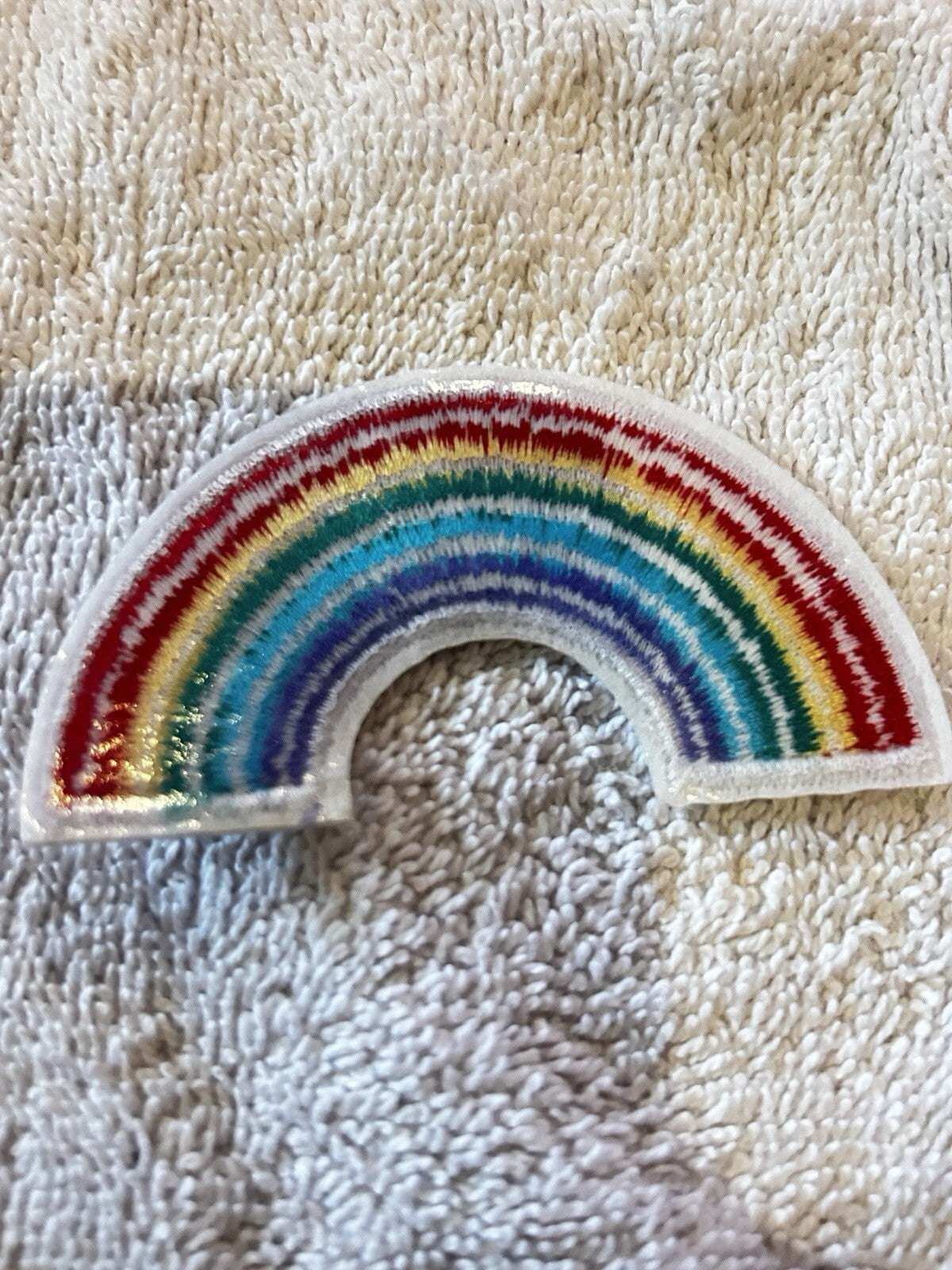 Rainbow embroidered iron-on patch 3x2 inches with colorful rainbow design for bags, jackets, and jeans.