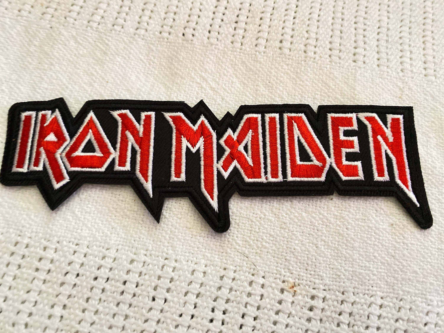 Iron Maiden logo patch with bold red and white lettering on black background for heavy metal fans