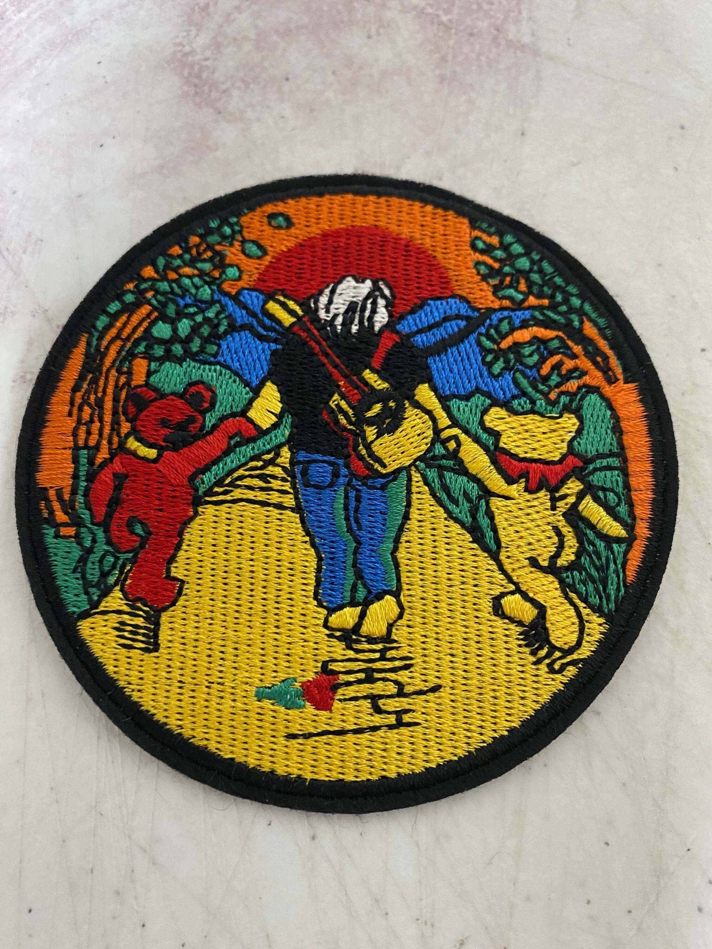 Grateful Dead Jerry Garcia patch with vibrant sunset and dancing bears design