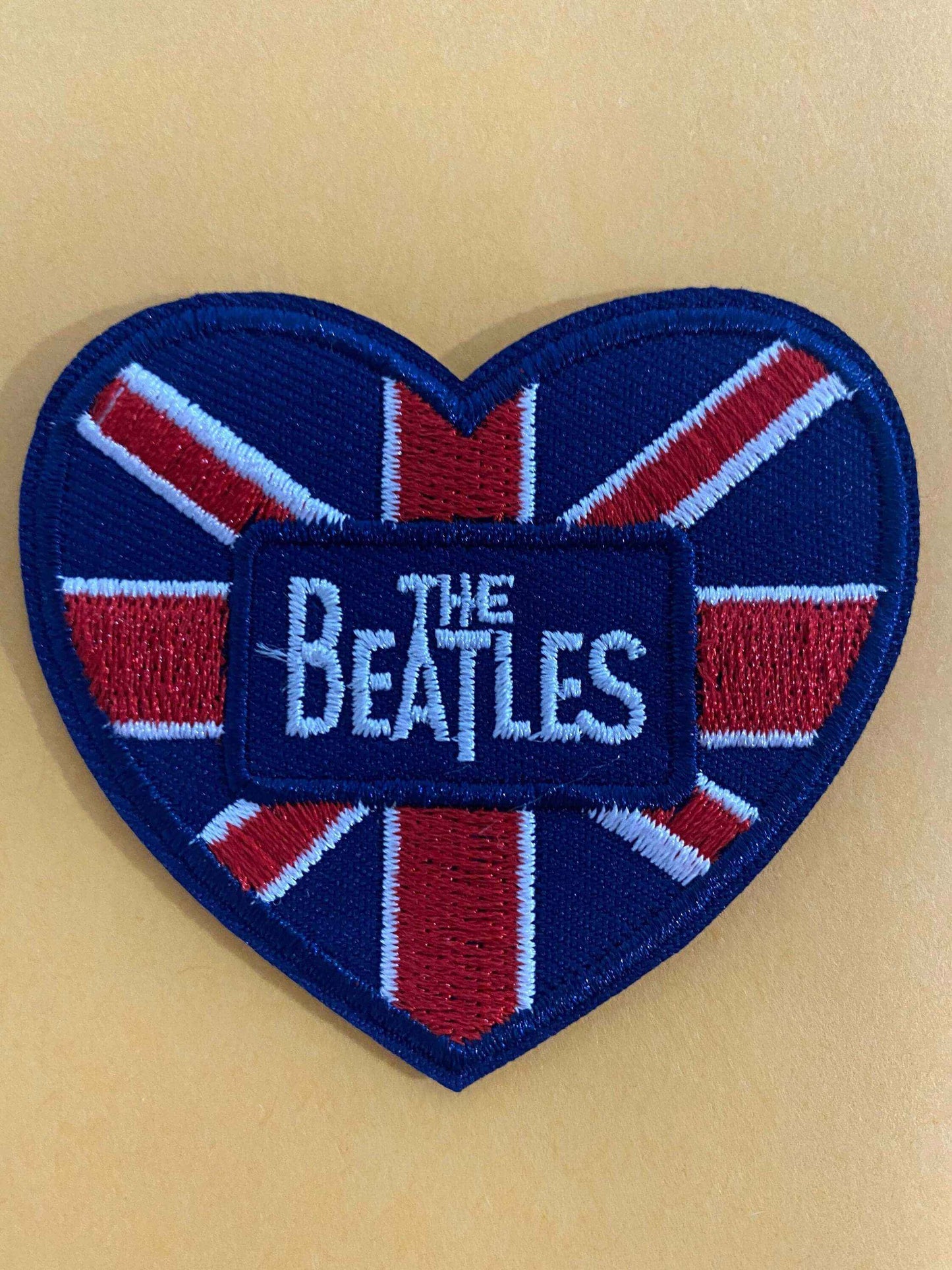 Heart-shaped embroidered patch with Union Jack design and "The Beatles" text in the center