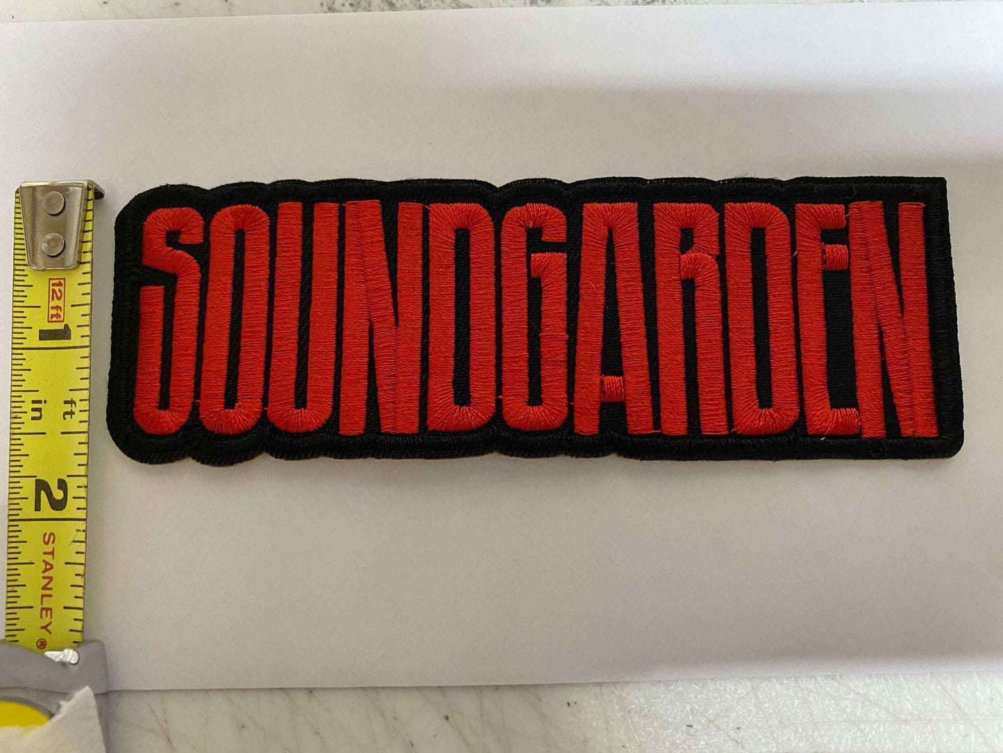 Embroidered Soundgarden patch with bold red letters on black background measuring about 5 inches long