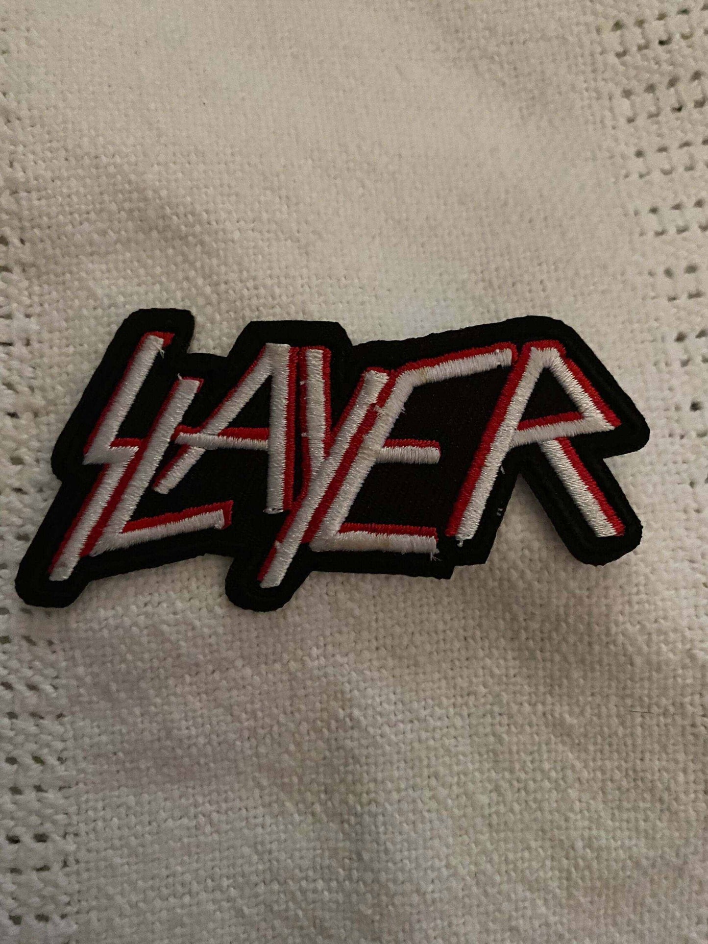 Slayer band logo patch with bold red and white lettering on black background