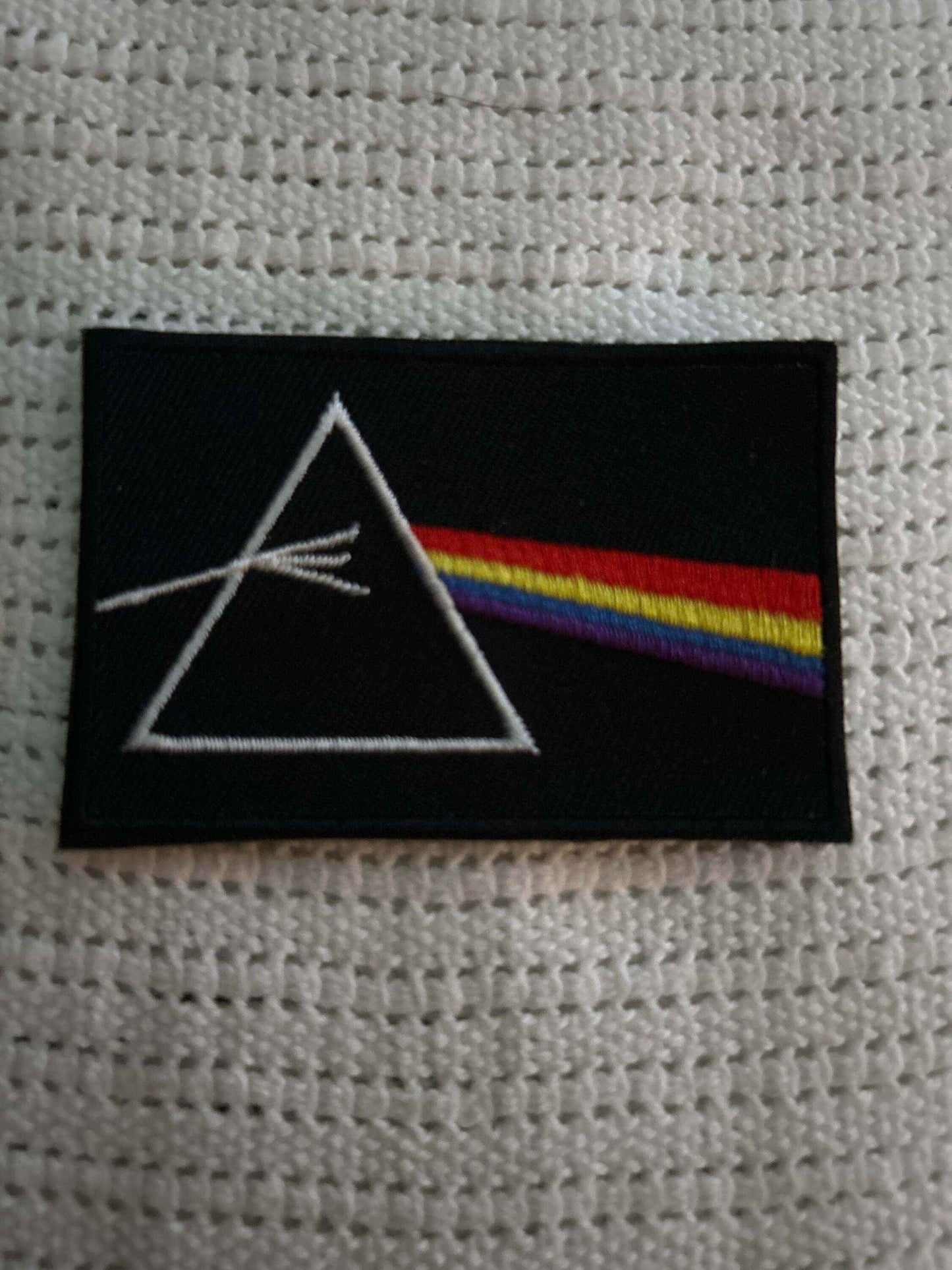 Dark Side of the Moon patch featuring a prism with a rainbow spectrum on a black background