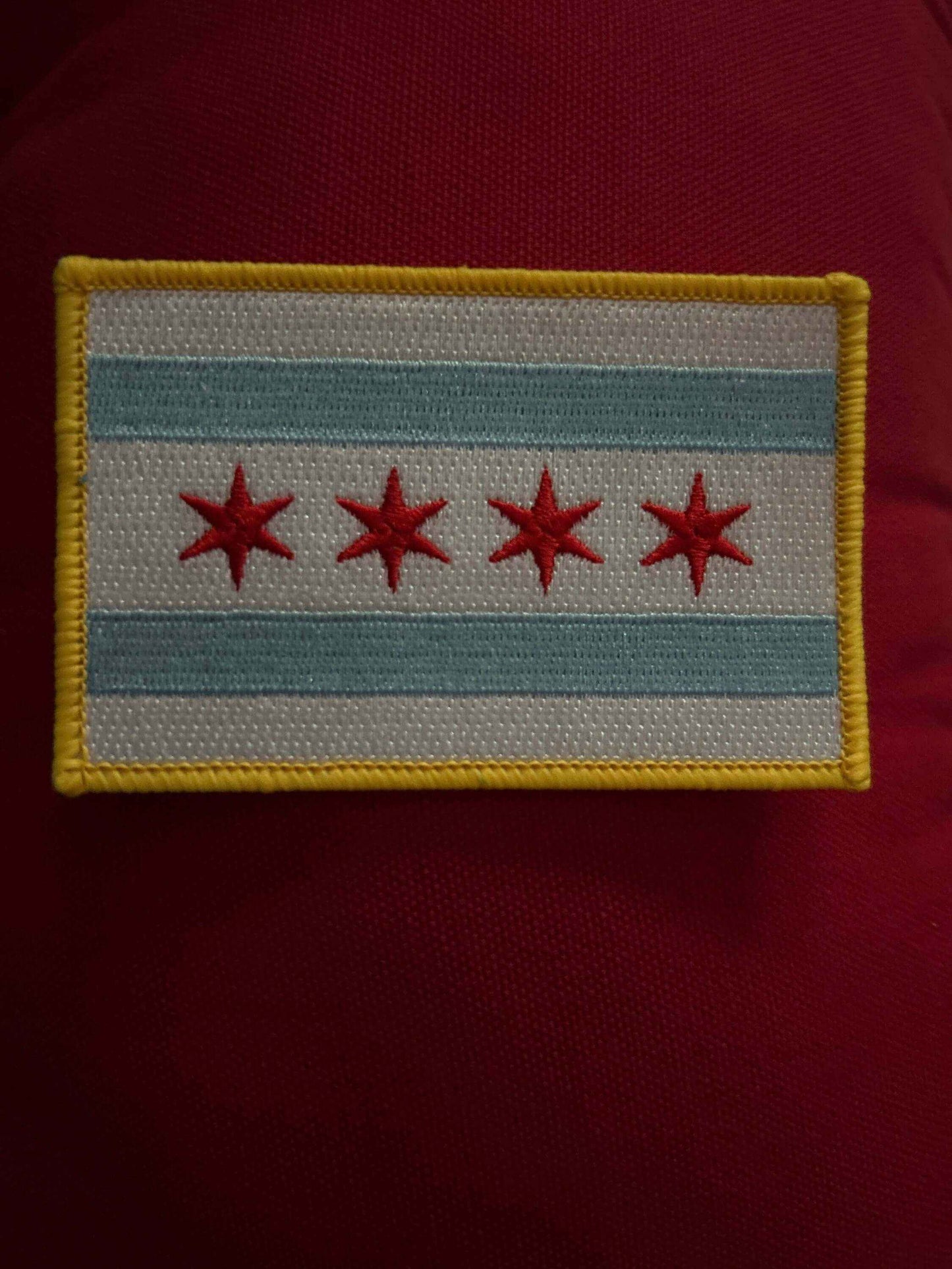 Chicago PD patch with four red stars and blue stripes on a white background with yellow border
