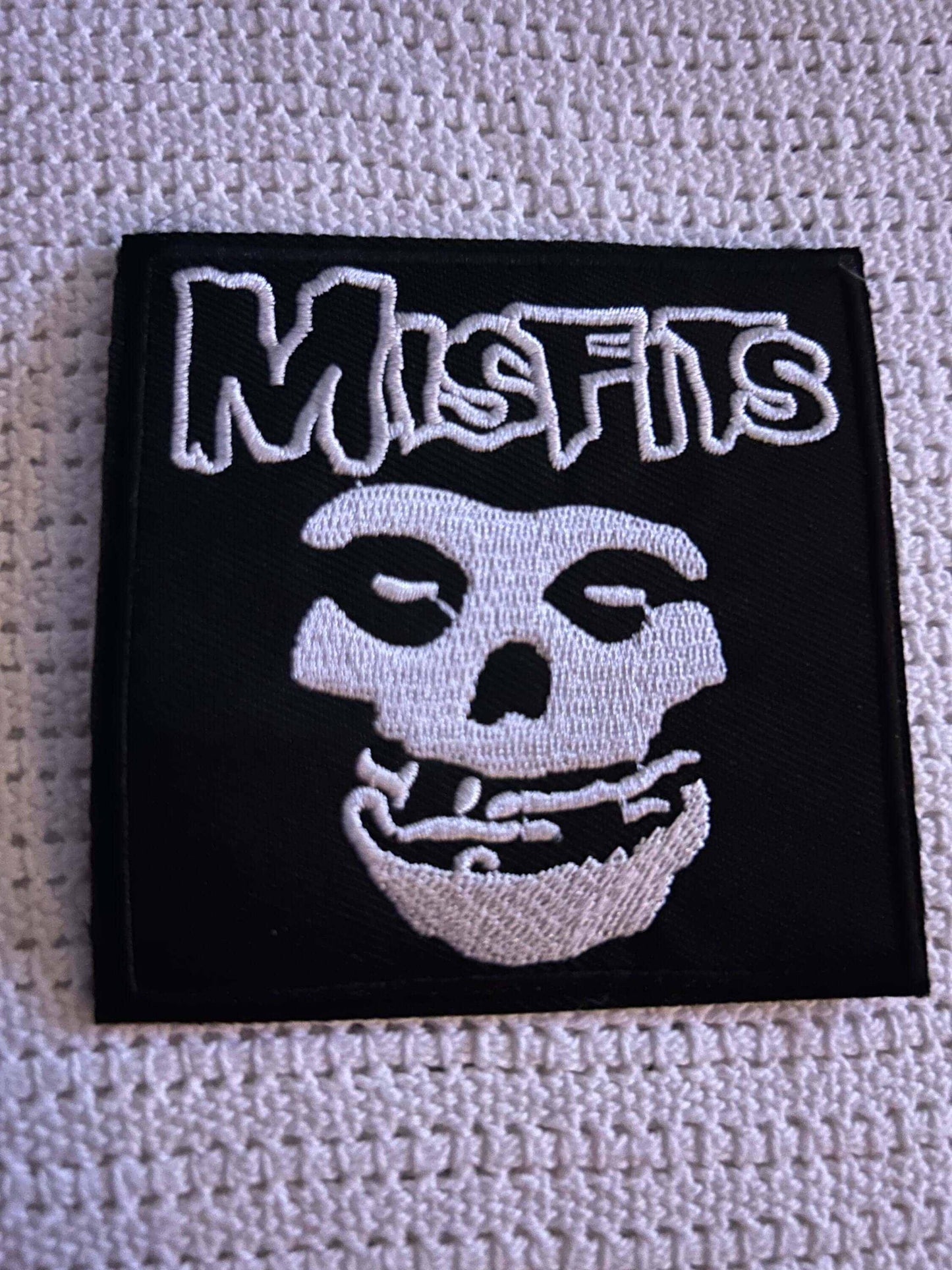 Black embroidered Misfits patch featuring white Fiend Skull logo and band name text