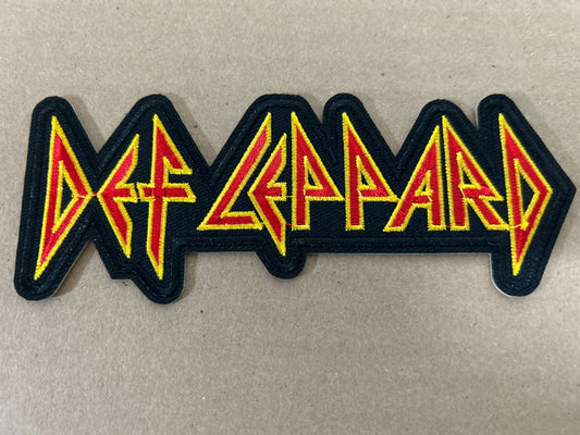 Def Leppard embroidered patch design featuring bold yellow and red lettering.