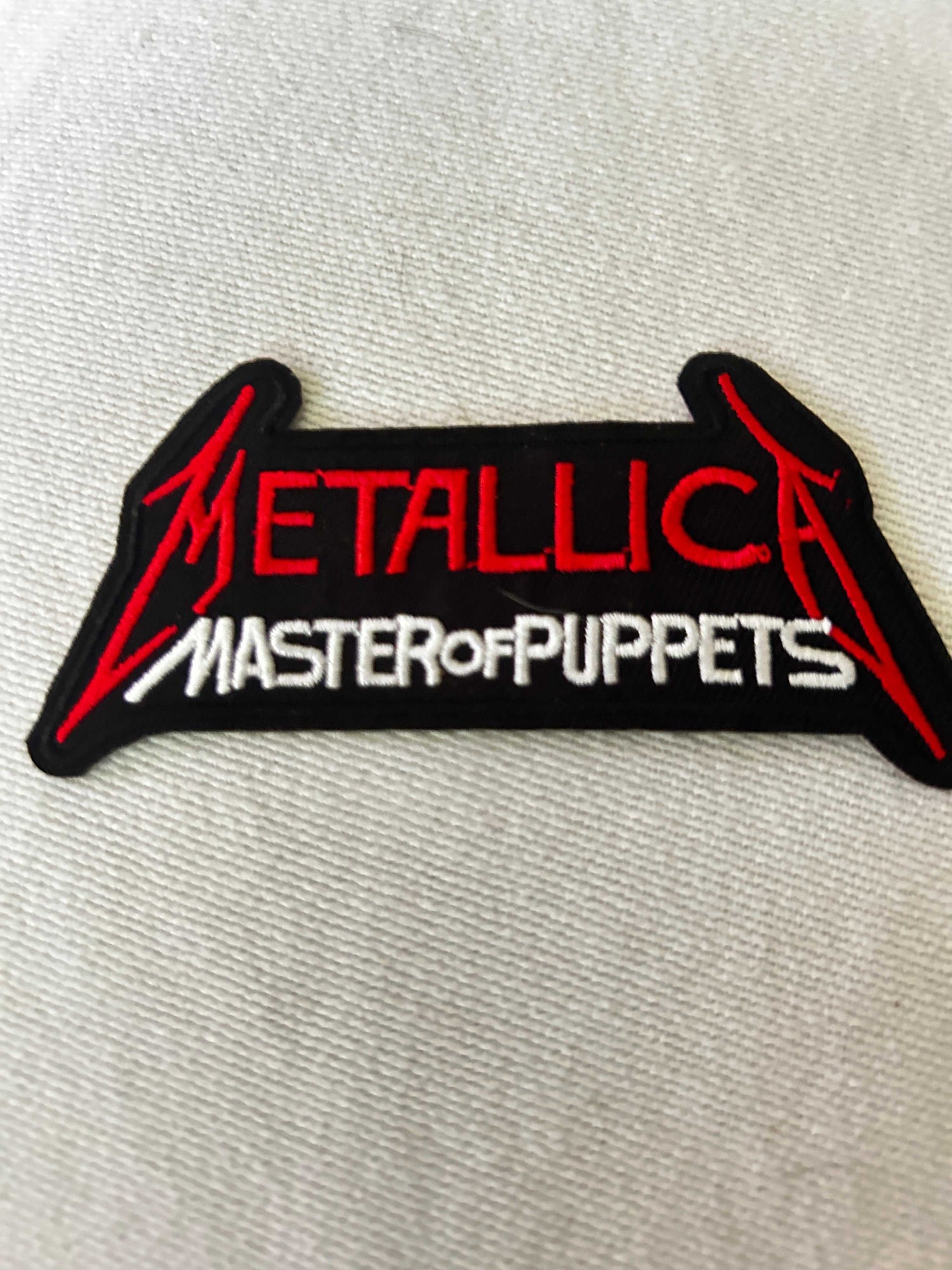 Collection of iconic heavy metal band patches including Metallica, Iron Maiden, Black Sabbath, and Slayer