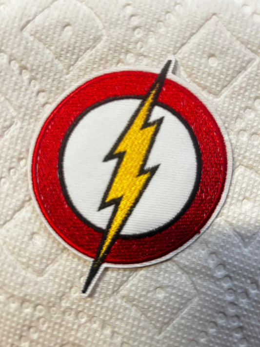 The Flash 3-inch iron on logo patch with red and yellow lightning bolt emblem on white background