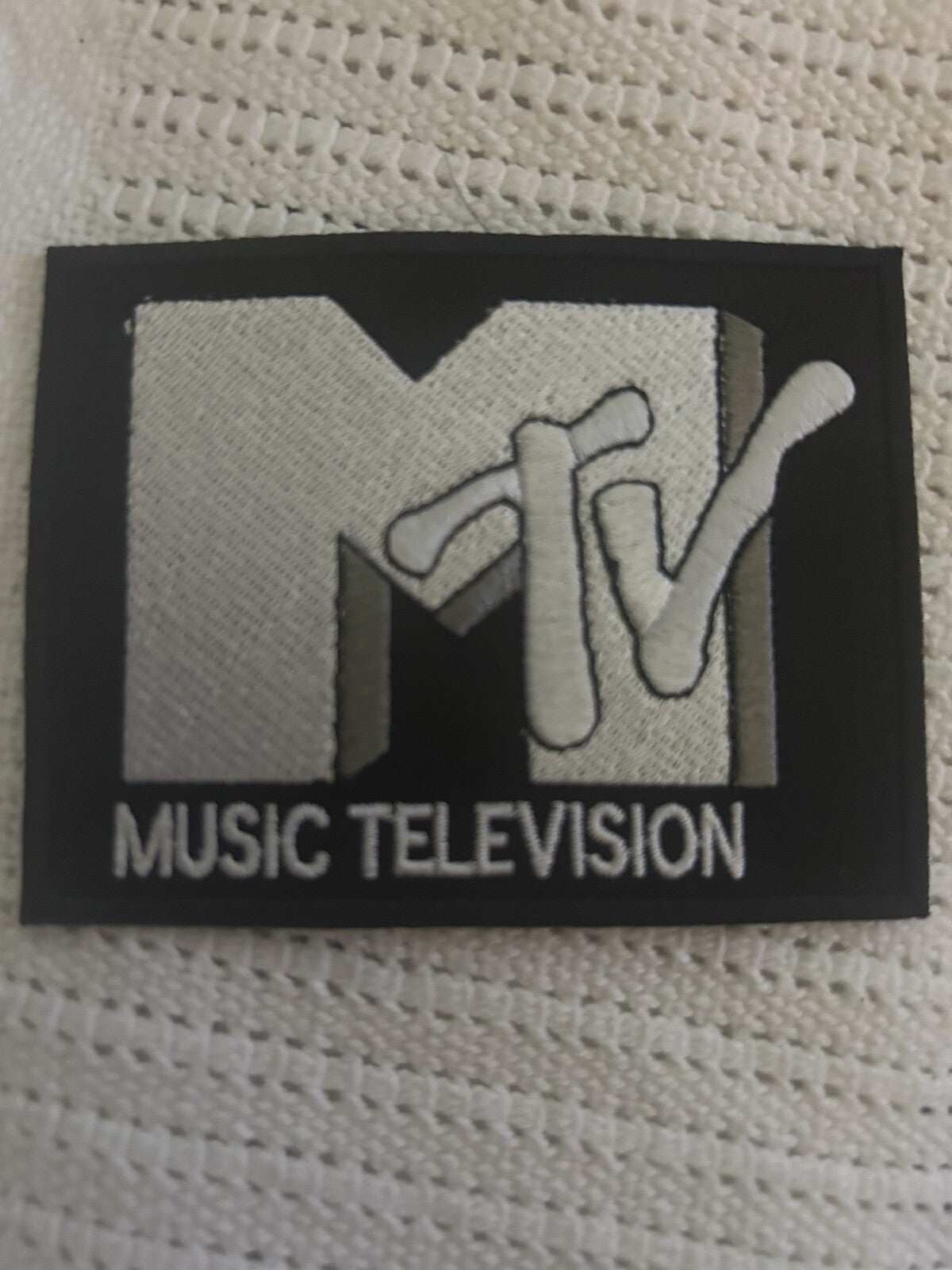 Black and silver MTV embroidered iron-on patch 3.5x2.75 inches for jackets and bags