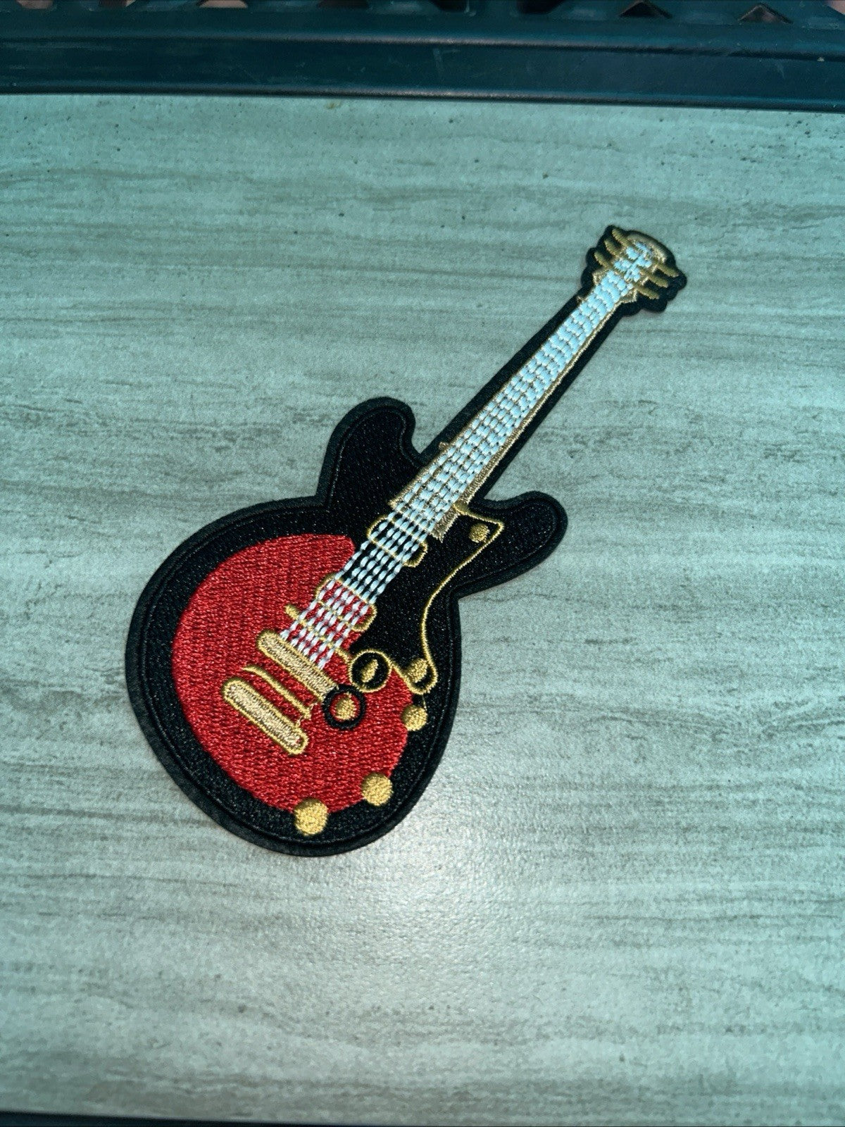 Red electric guitar embroidered iron-on patch for music-themed apparel and accessories, 2.25"x5.5"