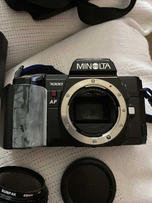 Minolta 7000 SLR black 35mm film camera with 50mm f/1.7 lens and Milisi electronic flash